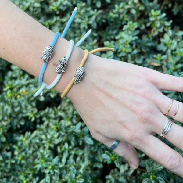 Blue, brown and white PTES hedgehog charm bracelet